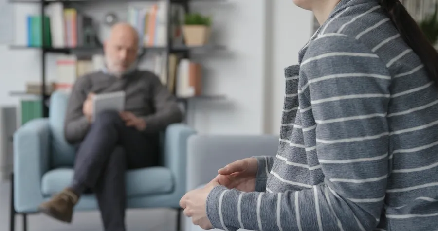 Client meeting with a counselor in a modern, comfortable office